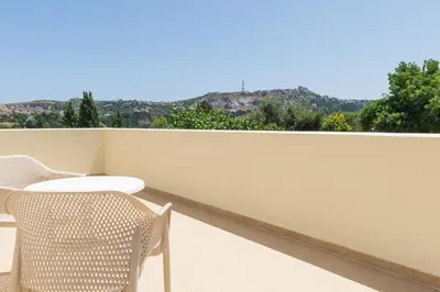 a balcony with a table and chairs and a view at Palamoutaki Villa in Koskinou