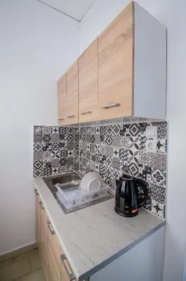 a kitchen with a sink and a counter top at CHAMBRE JAUNE in Ialyssos