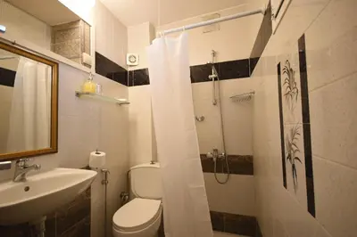 a bathroom with a toilet and a sink and a shower at Masì House in Rhodes Town