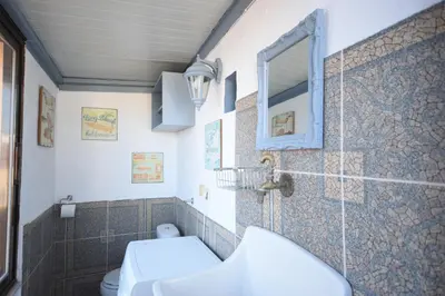 a bathroom with a toilet and a mirror at Masì House in Rhodes Town