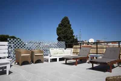 a group of chairs and tables on a patio at Masì House in Rhodes Town