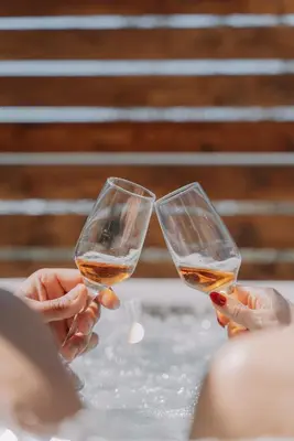 two people are holding glasses of wine at Marvinas seaside apartments, GAIA apartment & HYDOR jacuzzi apartment in Kremasti