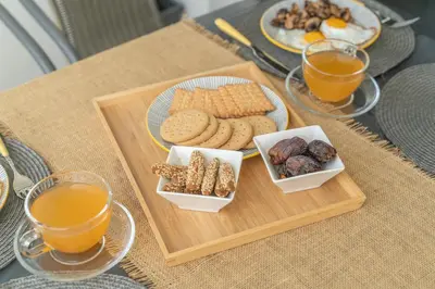 a table with a tray of cookies and orange juice at Marvinas seaside apartments, GAIA apartment & HYDOR jacuzzi apartment in Kremasti