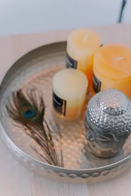 a glass bowl with candles and a bird in it at Marvinas seaside apartments, GAIA apartment & HYDOR jacuzzi apartment in Kremasti