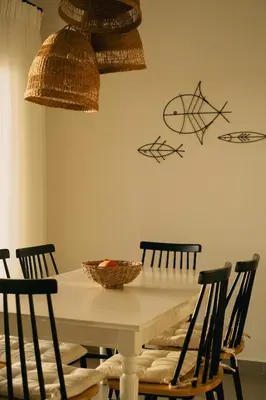 a dining room table with chairs and baskets on the wall at Alykes Beachside Stylish Villas with Private Pool South Rhodes in Lachania