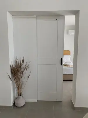 a room with a door and a vase with a plant at Alykes Beachside Stylish Villas with Private Pool South Rhodes in Lachania