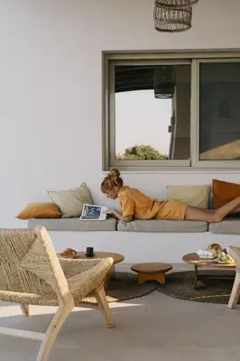 a young child laying on a couch in a living room at Alykes Beachside Stylish Villas with Private Pool South Rhodes in Lachania