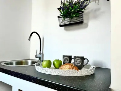 a kitchen counter with a plate of food and a sink at Villa Krokali Lindos in Líndos