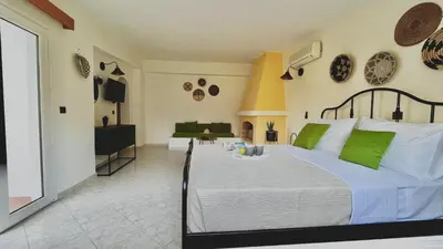 a bedroom with a large bed with green pillows at Villa Krokali Lindos in Líndos