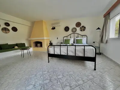 a bedroom with a bed and a living room at Villa Krokali Lindos in Líndos