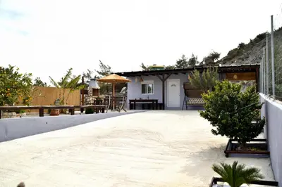 a patio with a house in the background at PLUMERIA HOUSE in Archangelos