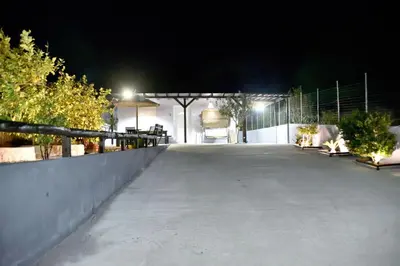 a driveway leading to a garage at night at PLUMERIA HOUSE in Archangelos