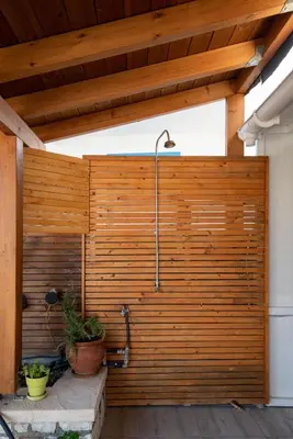 a wooden fence with a shower in it at Searock Stegna Villa in Archangelos