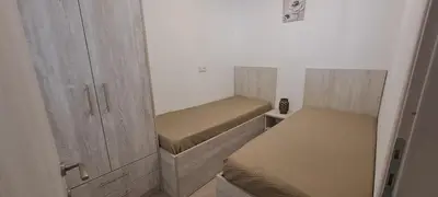 a small room with two beds and cabinets at Searock Stegna Villa in Archangelos