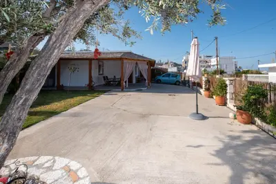 a house with a tent and a flag in the driveway at Searock Stegna Villa in Archangelos
