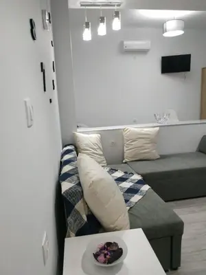 a living room with a couch and a table at Ioanna Studio Διαμέρισμα κοντά στη θάλασσα. in Kolimbia