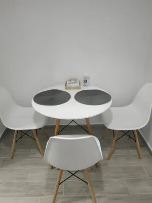 a white table with four white chairs around it at Ioanna Studio Διαμέρισμα κοντά στη θάλασσα. in Kolimbia