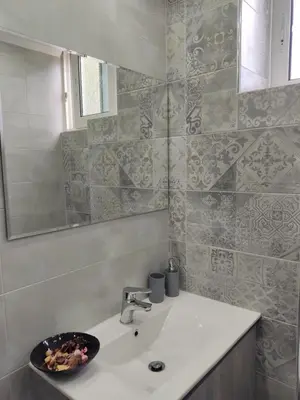 a bathroom with a sink and a mirror at Ioanna Studio Διαμέρισμα κοντά στη θάλασσα. in Kolimbia