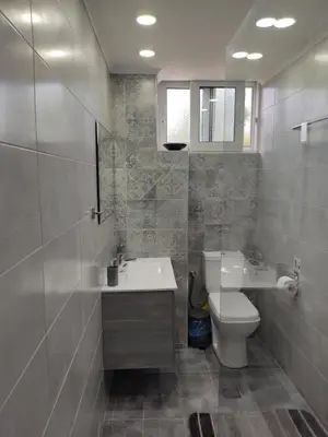 a bathroom with a sink and a toilet at Ioanna Studio Διαμέρισμα κοντά στη θάλασσα. in Kolimbia