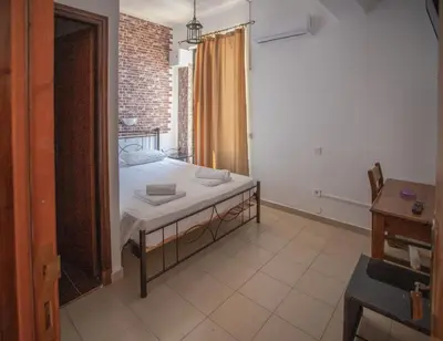 a bedroom with a bed in a room with a window at Star Sianna Village Rooms to let in Siána