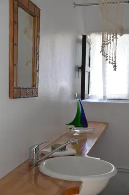 a bathroom counter with a sink and a mirror at Spitaki - House with Garden by the Beach - Pefki in Pefki Rhodes
