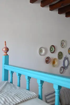 a blue rail with plates on a wall at Spitaki - House with Garden by the Beach - Pefki in Pefki Rhodes