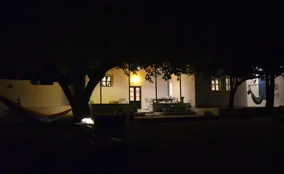 a tree and a hammock in front of a building at Spitaki - House with Garden by the Beach - Pefki in Pefki Rhodes