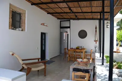 a living room with a table and chairs at Spitaki - House with Garden by the Beach - Pefki in Pefki Rhodes