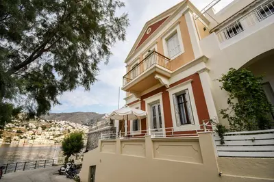 a house with a view of the water at anoi tholos in Symi