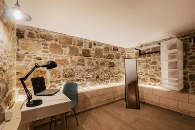 a room with a desk with a laptop and a lamp at Villa Gemma in Haraki