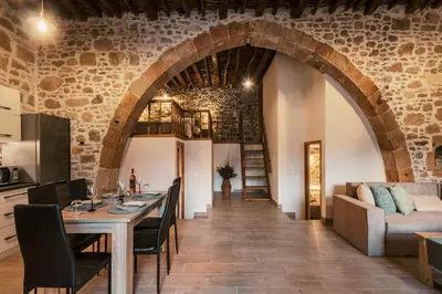 a kitchen and living room with a table and a couch at Villa Gemma in Haraki