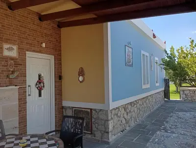a porch of a house with a table and chairs at Athinas Art House in Kolimbia