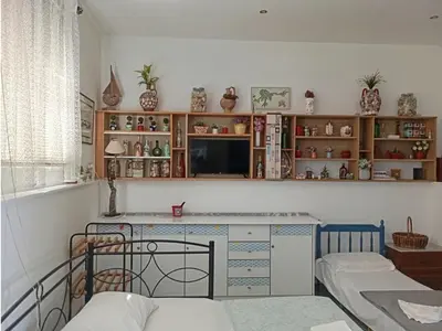 a living room with a desk and shelves at Athinas Art House in Kolimbia