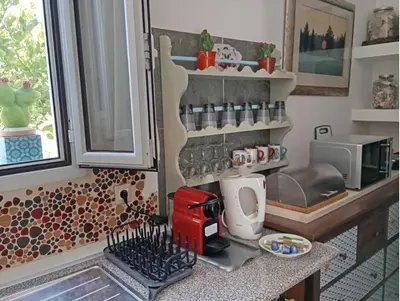 a kitchen with a counter with a coffee maker on it at Athinas Art House in Kolimbia