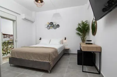 a bedroom with a bed and a table and a window at Luxury apartment in the center in Rhodes Town
