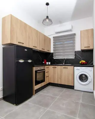 a kitchen with a black refrigerator and a dishwasher at Luxury apartment in the center in Rhodes Town
