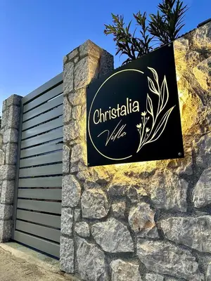 a sign for a christiania villa on a stone wall at Villa Christalia in Kolimbia