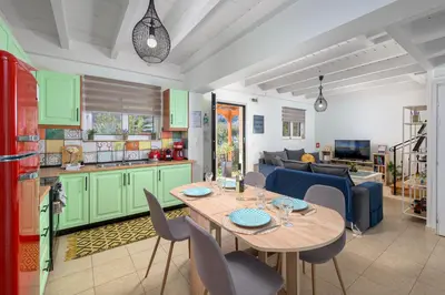 a kitchen and a living room with a table and chairs at Villa Christalia in Kolimbia