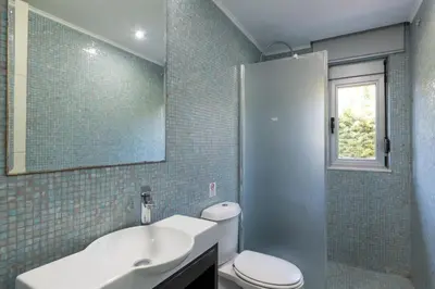 a bathroom with a sink and a toilet and a mirror at Marane Deluxe House in Ialyssos