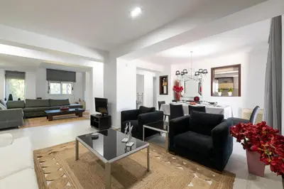 a living room with a couch and a table at Marane Deluxe House in Ialyssos