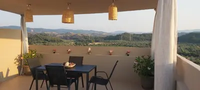 a blue table and chairs on a balcony with a view at Annas House Theologos in Theologos