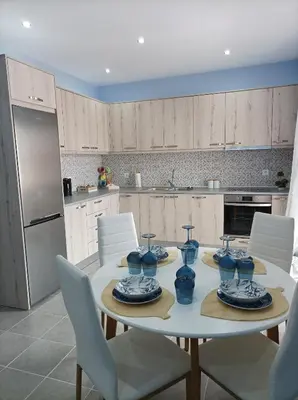 a kitchen with a table with blue vases on it at Annas House Theologos in Theologos