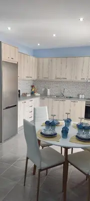 a kitchen with a table with blue dishes on it at Annas House Theologos in Theologos
