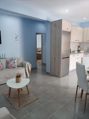 a living room with a couch and a kitchen at Annas House Theologos in Theologos