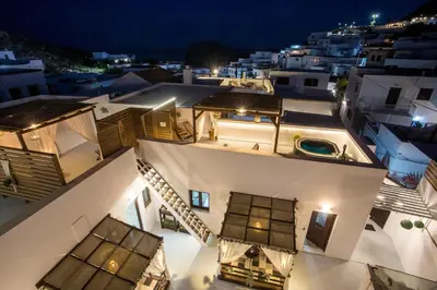 a view of the rooftops of buildings at night at Bliss Luxury Suites in Líndos