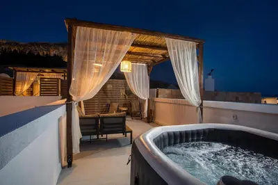 a hot tub on the roof of a house at Bliss Luxury Suites in Líndos
