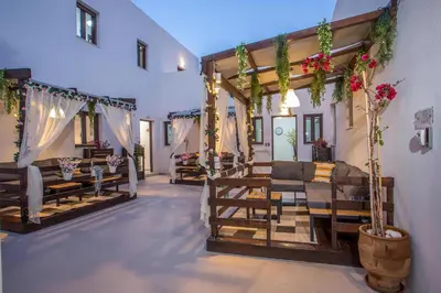 a room with couches and tables and flowers on the wall at Bliss Luxury Suites in Líndos