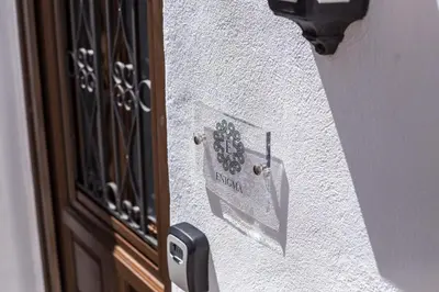 a door with a sign on the side of a building at Heritage Luxury Suites in Líndos
