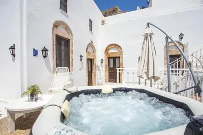 a hot tub on the patio of a house at Heritage Luxury Suites in Líndos