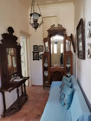 a living room with a blue couch and a mirror at GIANNAS HOUSE in Symi